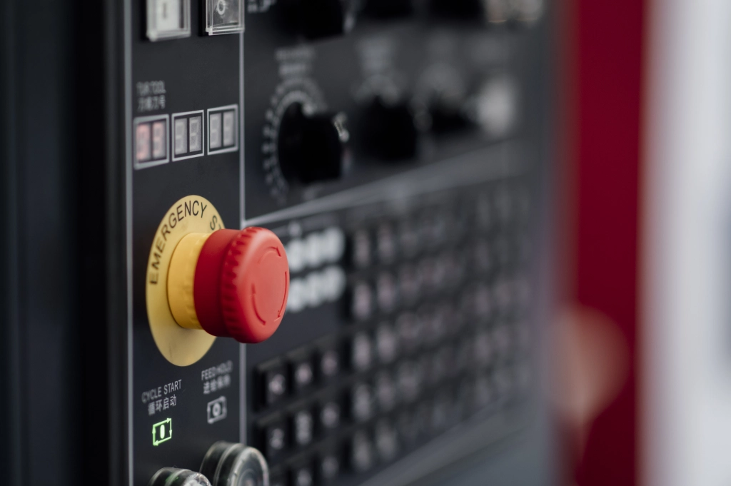 emergency stop on industrial machinery control panel for machine safety